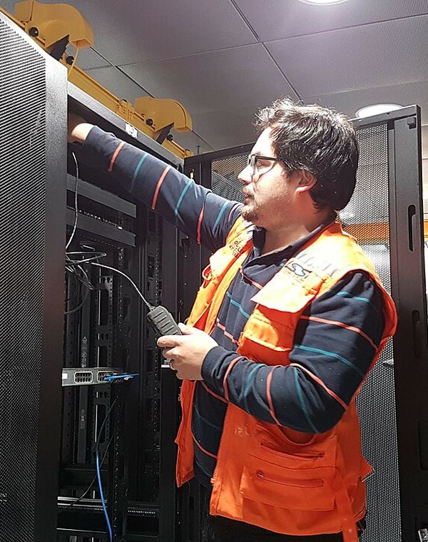 Engineer cabling a server rack